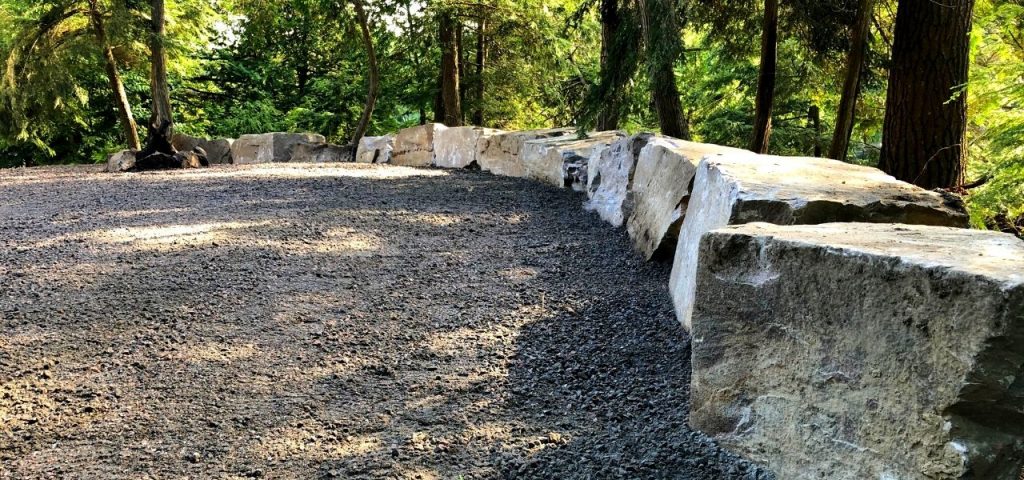 armour stone retaining wall and parking lot gravel